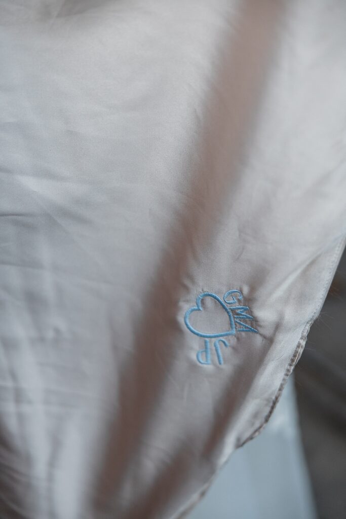 Blue embroidery on a wedding gown is photographed at a Las Vegas Lakeside wedding